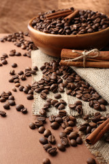 Coffee beans on table on brown background