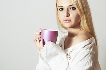 Beautiful blond woman drinking Coffee.Cup of tea.Hot drink