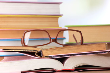 Composition with glasses and books,