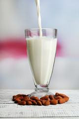 Almond milk is poured into glass,