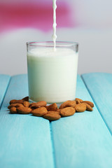 Almond milk is poured into glass,