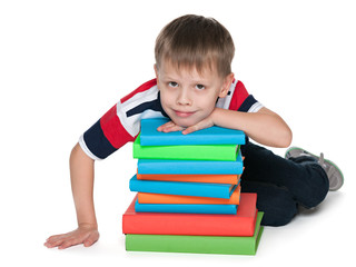 Pensive young boy with books