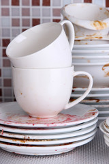 Dirty dishes on bright background