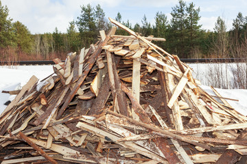 Fototapeta na wymiar Pile of boards procured as firewood