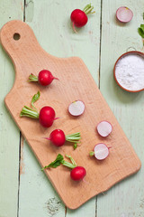 Naklejka na ściany i meble Fresh radish on wooden cutting board