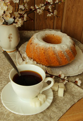 Coffee cup,cake and flowering branch of apricot .