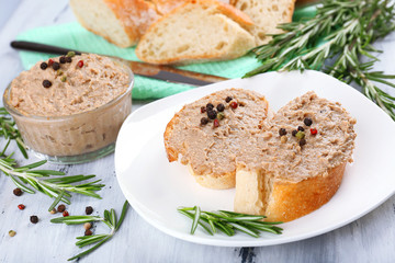 Fresh pate with bread on wooden table
