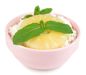 Bowl of tasty cottage cheese with pineapple, isolated on white