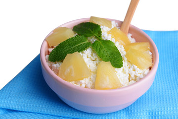 Bowl of tasty cottage cheese with pineapple, close up