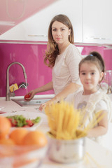 Mother and daughter cooking in the kitchen