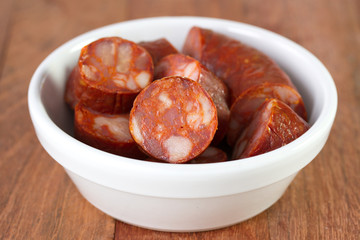 chourico in bowl in brown background