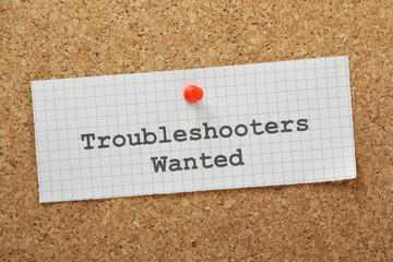 Troubleshooters Wanted on a cork notice board