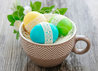 Colorful Easter eggs in a decorative cup