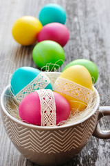 Colorful Easter eggs in a decorative cup