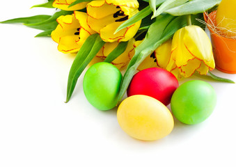 Easter eggs with tulips on white background