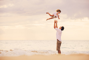 Father and Daughter Playing Together at the Beach at Sunset