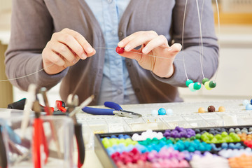Artisan in workshop creating a necklace