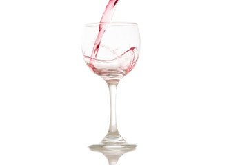 wine and a glass pouring on a white background