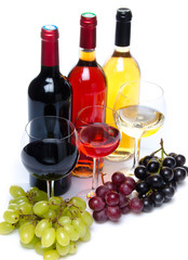 Bootles and glasses of wine with black, red and white grapes