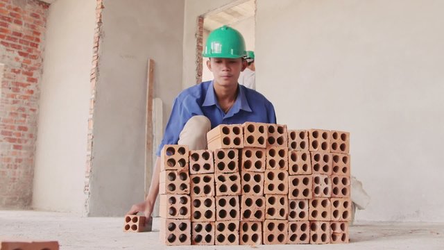 23of23 Building activity with asian man working with bricks