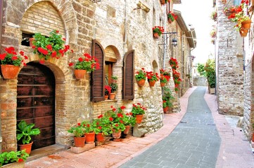 Picturesque lane with flowers in an Italian hill town - obrazy, fototapety, plakaty