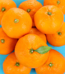Ripe sweet tangerines, on color background