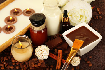 Beautiful chocolate spa setting on wooden table close-up