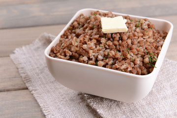 Boiled buckwheat in bowl on table close-up