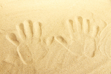 Hand prints in sand as nice summer background
