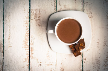 Cup of hot chocolate on wooden background