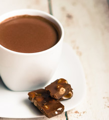 Cup of hot chocolate on wooden background