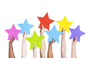 Multi-Ethnic Arms Raising Colorful Blank Stars for Copy Space
