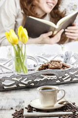 Time to relax: young woman enjoying reading a book