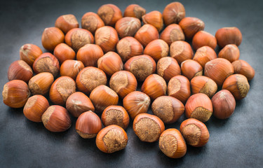 Hazelnuts on dark background. Selective focus.