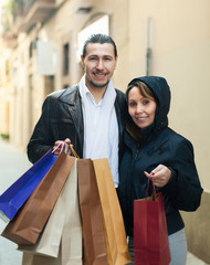 couple with purchases at street