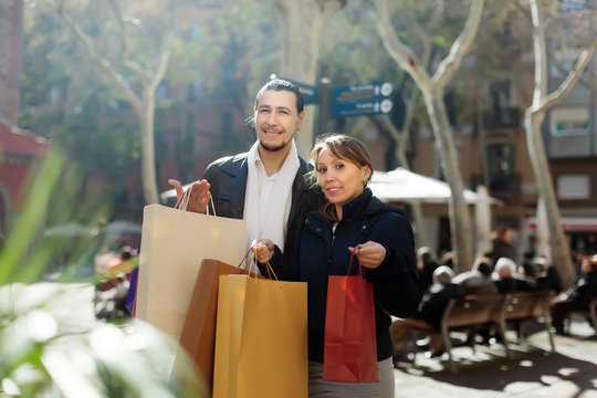Smiling couple   with purchases at  street