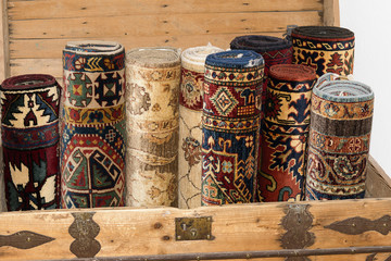 rolled up turkish carpets in a kist