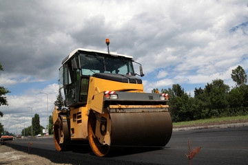 Large road-roller paving a road. Road construction