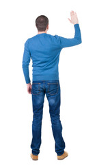 Back view of handsome man in blue pullover  looking up.