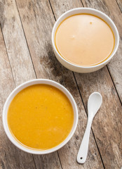 Pumpkin cream soup on old wooden table