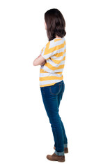 back view of standing young beautiful  brunette woman in yellow