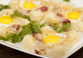   Sandwich with quail egg and ham on the puff pastry.