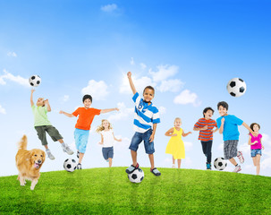 Obraz na płótnie Canvas Multi-Ethnic Children Playing Soccer Outdoors