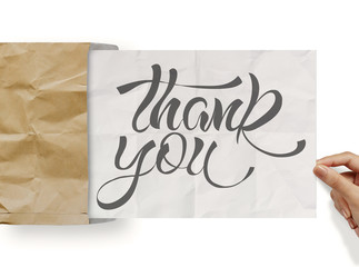 businessman hand show design word THANK YOU on crumpled paper as