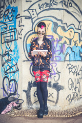 Fototapeta na wymiar young beautiful punk dark girl using tablet