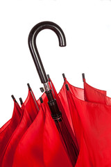 Closed red umbrella handle over white