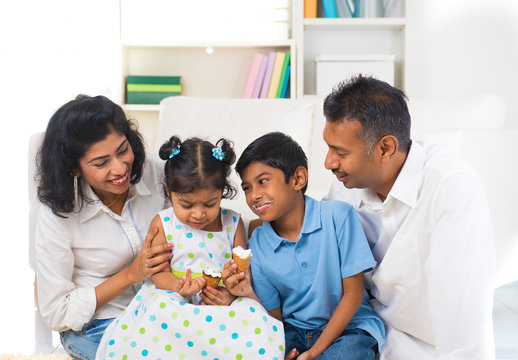 Happy Indian Family Enjoying Eating Ice Cream Indoor