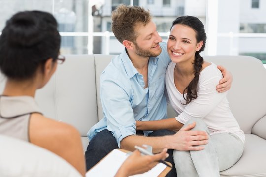 Happy couple reconciling at therapy session