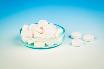 Petri dishes,  medicine tablet antibiotic pills. Laboratory conc