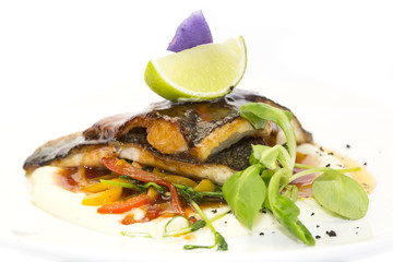 baked fish with vegetables and mushrooms in a restaurant